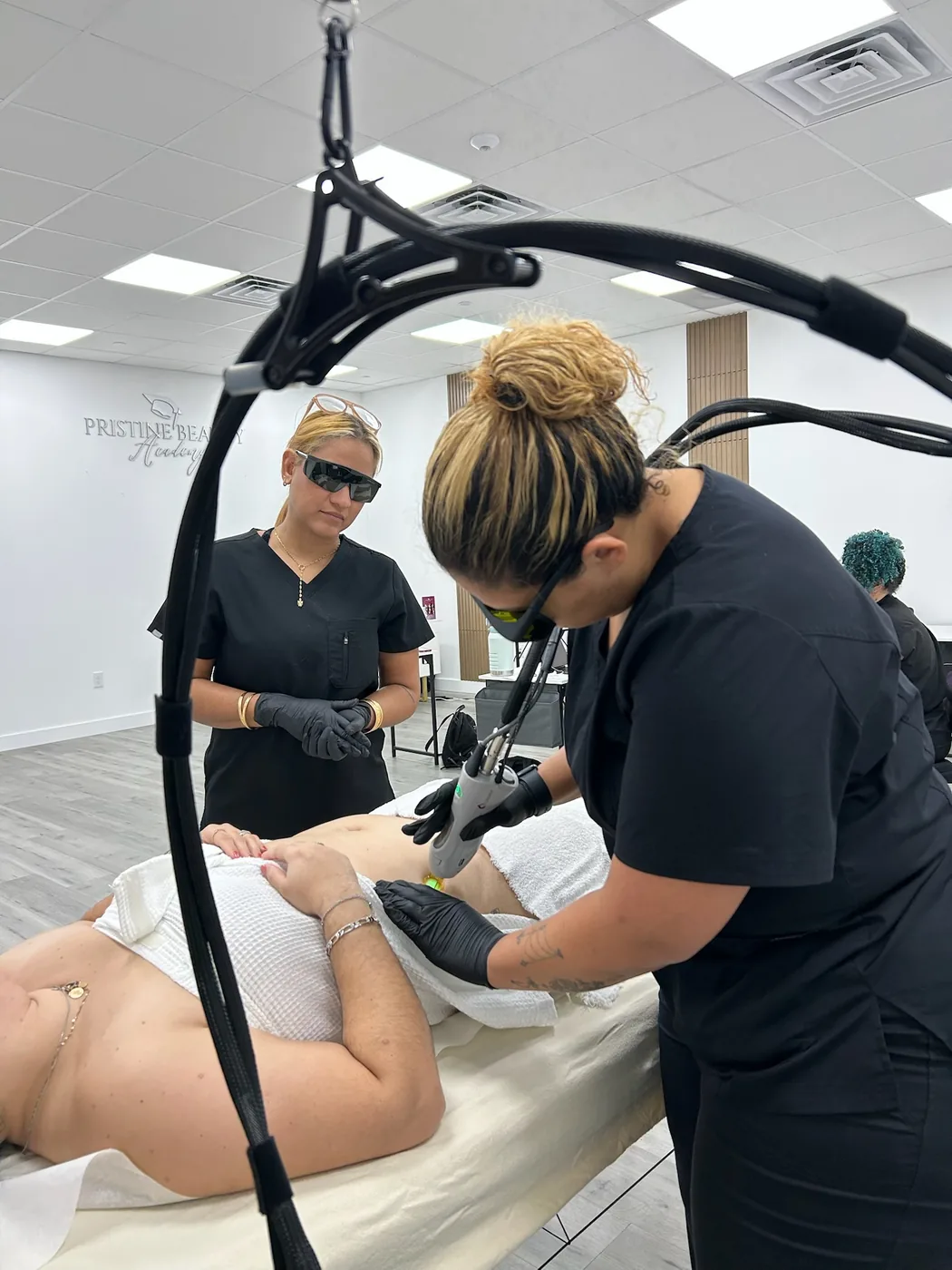 Two students performing a laser treatment with protective eyewear